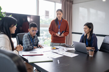 Asian business woman Application Designers presenting trending products report mobile application planning process development software design project ux Graphic designer