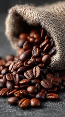 Roasted coffee beans spill from burlap sack