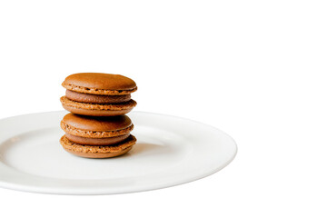 Exquisite Macarons: A close-up of three delectable macarons stacked on a pristine plate, inviting...