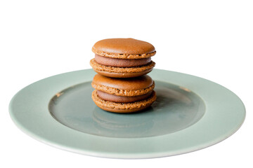 Chocolate Macarons on Plate: A stack of two elegant chocolate macarons sits perfectly poised on a simple pastel plate, creating a delicious contrast of textures and flavors.