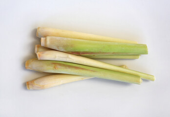 Lemon grass against white background, preparation process of lemon grass for cooking. Top view.