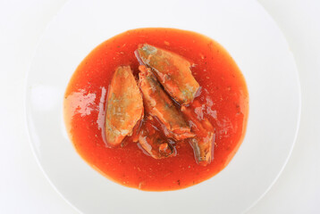 Juicy sardines or mackerel in rich tomato sauce, Beautifully served on a clean white plate.