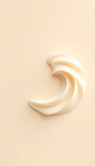 Swirling, Creamy Texture on a Light Beige Backdrop Displays Gentle Curves and Smooth Lines with a Minimalist Aesthetic