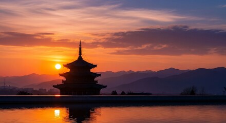 Pagoda silhouette at sunset with mountain landscape and water reflection tranquility