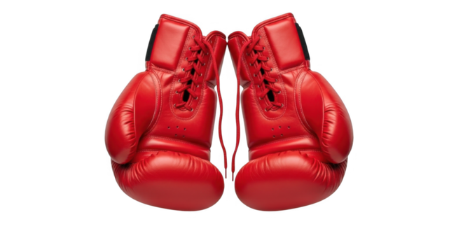 A pair of bright red boxing gloves hanging against a stark black background ready for a fight or training session for a strong opponent
