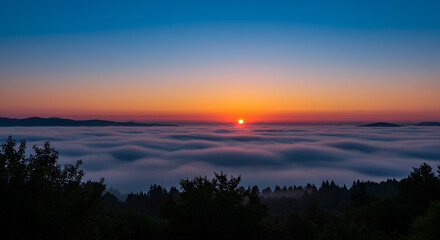 Obraz premium Serene mountain sunrise with layered peaks and orange sky