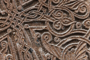 Close-up of a stone surface showcasing intricate ancient carved designs