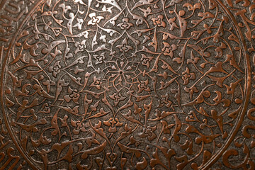 Decorative metal surface featuring precise handcrafted floral pattern
