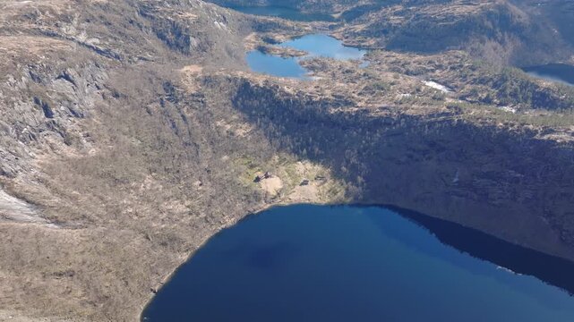 Drone circling above Kringlebotn mountain farm in Matrefjellene, capturing the old buildings and the panoramic mountains