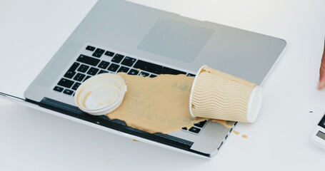 Laptop, coffee cup and spill beverage in office for accident, work chaos and keyboard damage....
