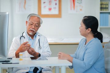 Male senior doctor discusses personalized medicine treatment with female patient hospital....