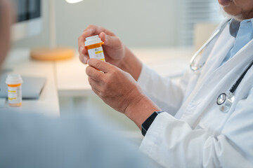 Male senior doctor discusses personalized medicine treatment with female patient hospital....