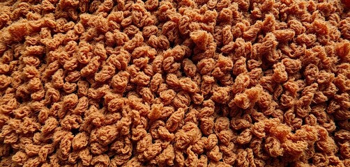 Close-up of coarse, textured brown fabric with visible fibers, homespun, brown background