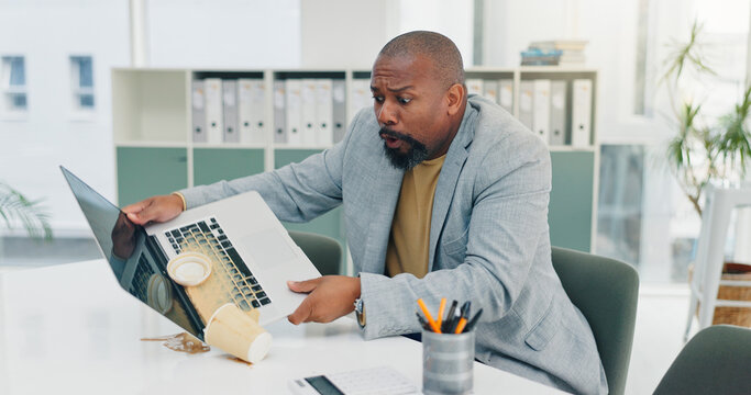 Business, black man and spill coffee on laptop with accident, work chaos and keyboard damage. Mature person, pc and mess drink on tech with clumsy employee, electronic insurance and hazard of mistake