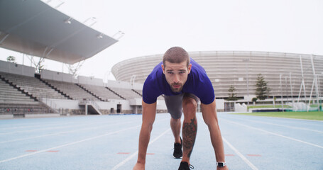 Man, runner and challenge with start line on stadium track for sprint, race or training lap....