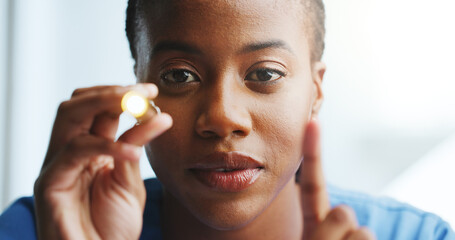 Woman, nurse and light for eye test, medical response or pupil for brain assessment. African...