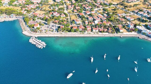 Foca 4k drone video with its windmills, marina and beaches in Izmir, Turkiye.
