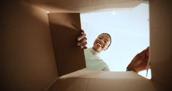 Black woman, open box and smile with POV in home, low angle or ecommerce for product, order or delivery. Person, excited and happy with cardboard package, shipment and online shopping at apartment