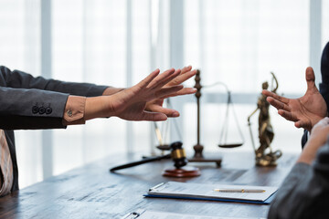 Naklejka na ściany i meble Two lawyers engaging in a discussion and gesturing animatedly during a meeting in a professional law office setting