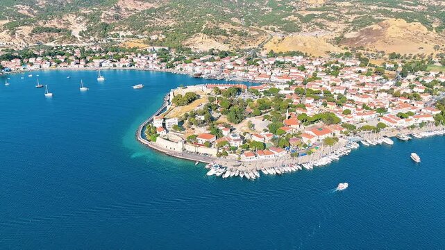 Foca 4k drone video with its windmills, marina and beaches in Izmir, Turkiye.