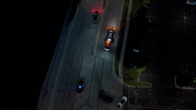 Road Accident at Night with Police Cars and Towing truck with damaged car. Aerial drone above shot