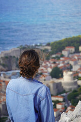 Fototapeta premium person looking at the panorama of the historic city