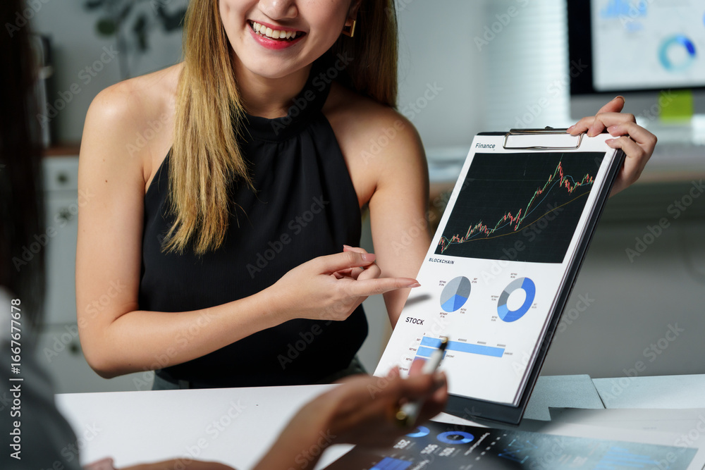 Poster smiling financial advisor pointing at positive charts and explaining investment strategy to client d