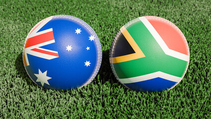 Two cricket balls featuring the flags of Australia and South Africa, on a grassy field
