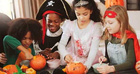 Children, halloween and group with pumpkin carving, decoration and creativity for costume party....