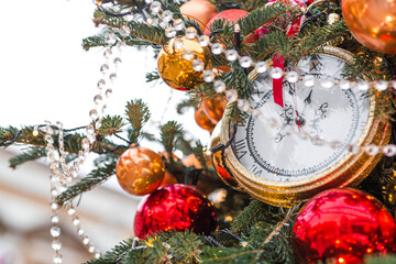 Golden retro clock on a decorated Christmas tree 2026. A beautiful background for New Year's Eve or...