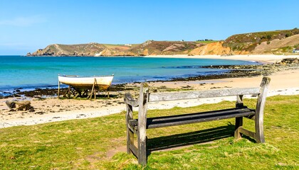 Tranquil Beachside Bench with Ocean View and Distant Cliffs.