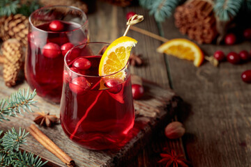 Christmas drink with cranberries, orange slices, and spices.