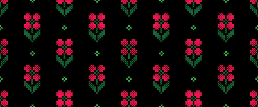 Seamless pattern with a cross-stitch embroidery effect. This traditional folk art design features pixelated red flowers and green leaves on a black background. A charming, vintage-style textile print.