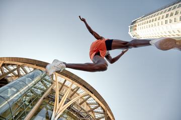 Athlete Jumps Over a Building Background Capturing Energy and Motion
