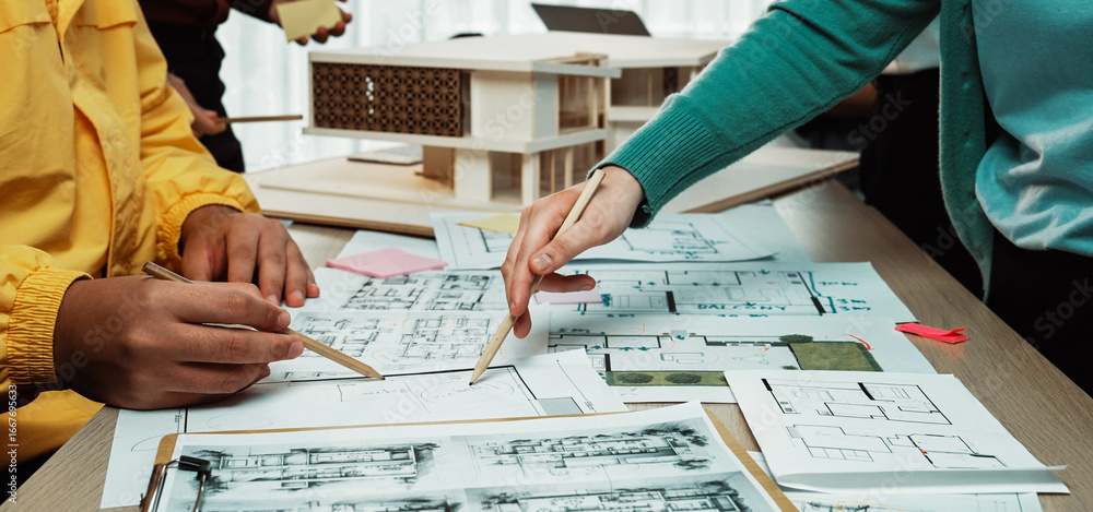Poster a vibrant architectural design meeting showcases hands actively sketching blueprints and analyzing m