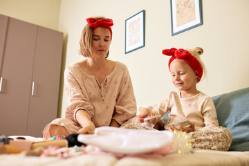 Mother and daughter bonding over crafts and playful activities