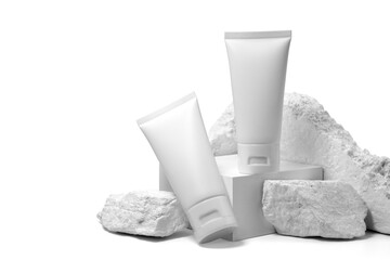 White plastic cream tube with stone for mockup isolated on white background. Selective Focus.