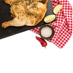 Roasted Chicken with Herbs, Lime, and Chili Peppers on a Slate Board. 