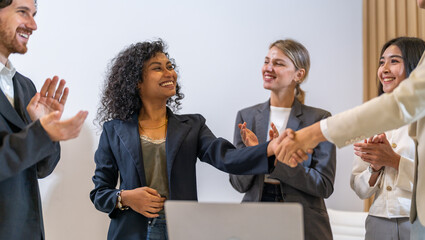 Multiracial team collaborating in modern office, diverse colleagues shaking hands during a business meeting, teamwork success, partnership agreement, professional collaboration multicultural workplace