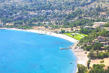 Fototapeta premium Marmaris Amos Bay shores. Blue sea and long beaches. Türkiye's natural beauties concept. Travel. Summer holiday. Top view, above. No people, nobody. Horizontal photo. 