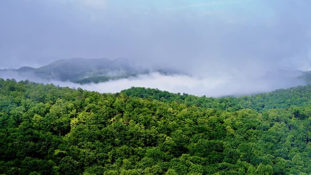 Mist swirls as a drone glides above the Smoky peaks.
