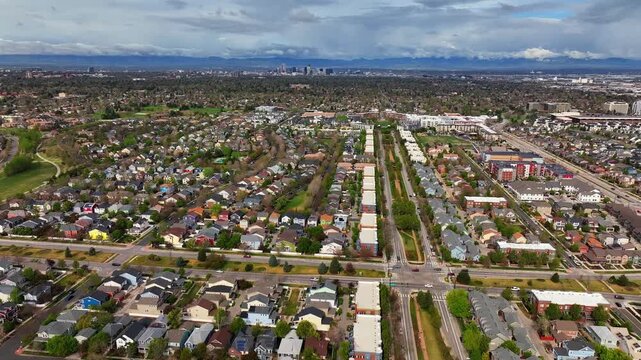 Front Range Denver Lowry Northfield Central Park neighborhood apartment buildings Colorado aerial drone sunny cloudy sky cloudy Lakewood Arvada Golden cars cityscape skyscrapers upwards motion