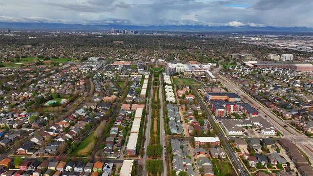 Front Range Denver Lowry Northfield Central Park Colorado aerial drone neighborhood apartment buildings sunny cloudy sky cloudy Lakewood Arvada Golden cars cityscape skyscrapers forward pan up motion