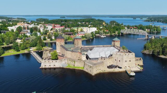 Panoramic drone shot around the Olafsborg Castle, sunny, summer day in Finland