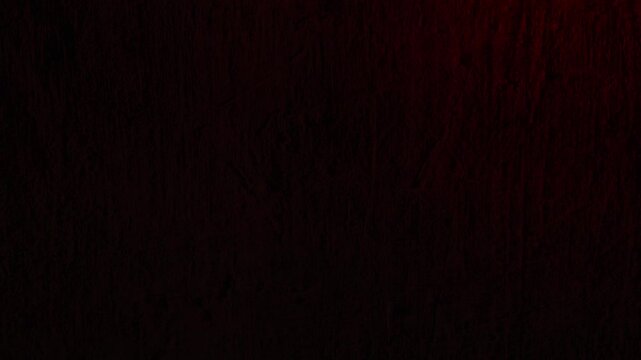 Red and blue police lights flash on dark textured wall, creating tense and urgent atmosphere for crime or emergency scenes