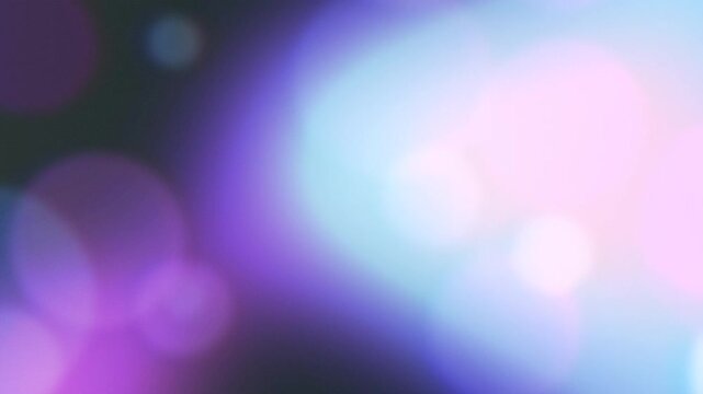 Softly Floating Purple and Blue Bokeh Lights Create a Dreamy, Atmospheric Motion Background.