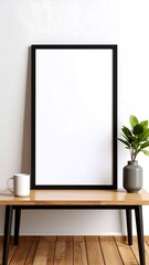 Blank framed poster on a wooden table