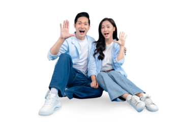 An excited couple waving their hands and expressing their emotion. The couple is smiling and sitting close to each other on PNG background