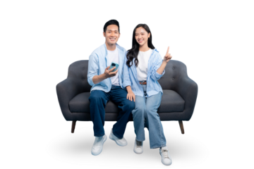 Young couple sitting on a couch using smartphone and pointing finger on PNG background