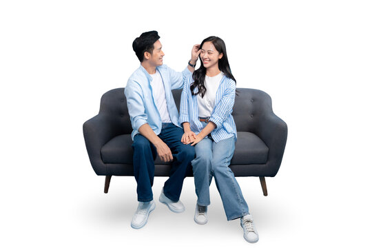 A happy couple sitting on a sofa together. This photo captures a beautiful moment of tenderness and affection on PNG background
